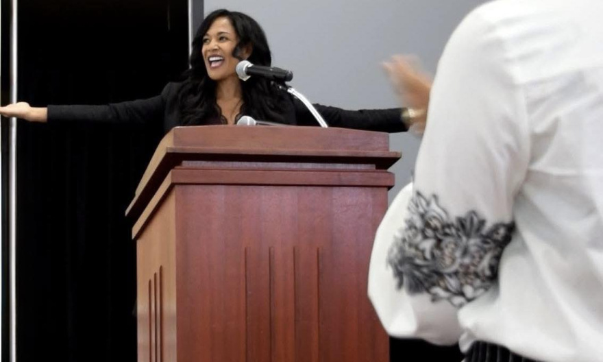 Kim Peterson delivering a keynote speech at Central Washington University Black Graduation, receiving a standing ovation for her message on authentic leadership and resilience