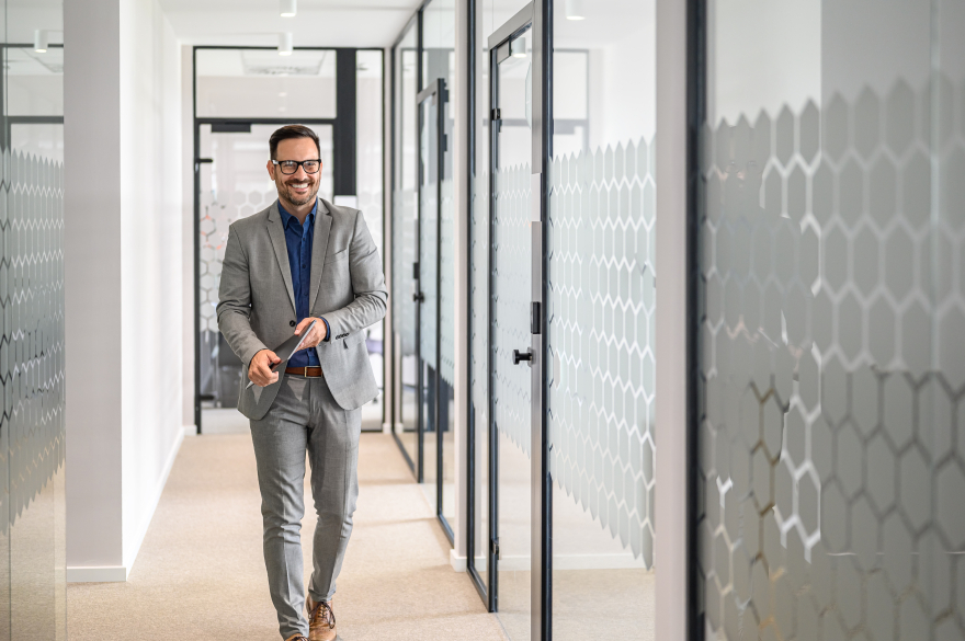 Confident executive adjusting blazer—authority, credibility, and first impressions