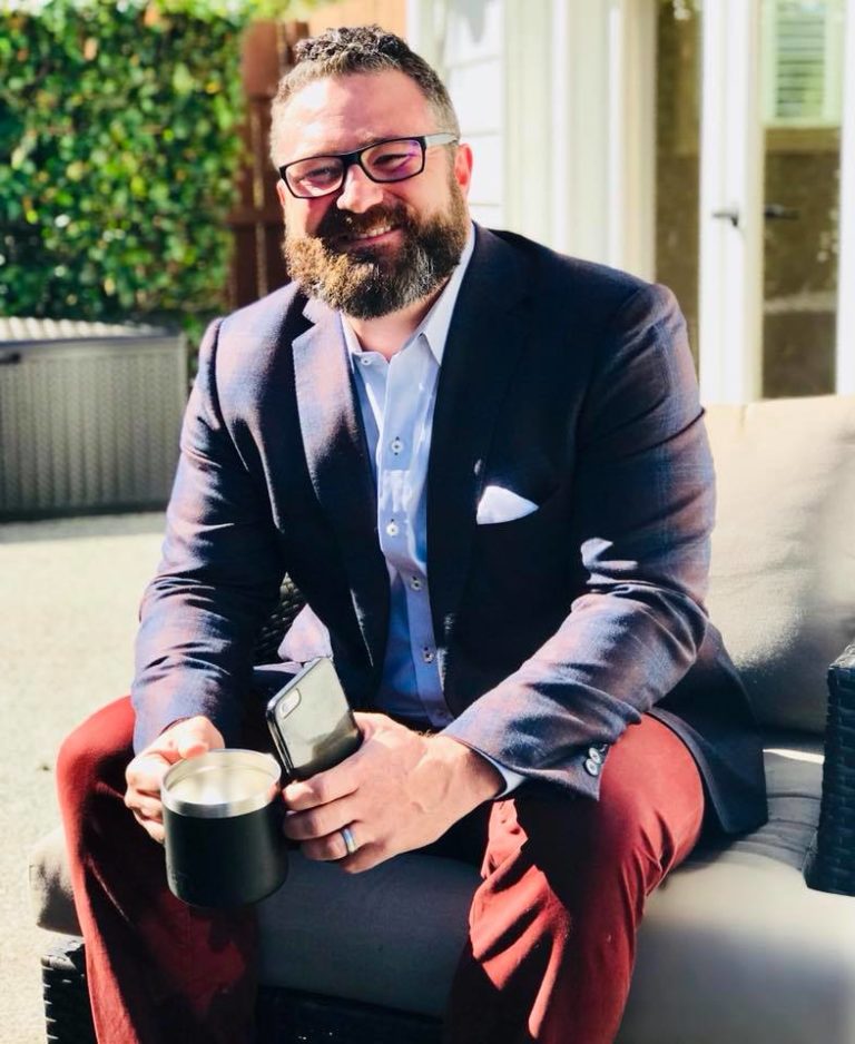 Man in business attire smiling with confidence—representing executive presence, professional style, and authentic leadership in Kim Peterson’s WHOLE YOU workshops.