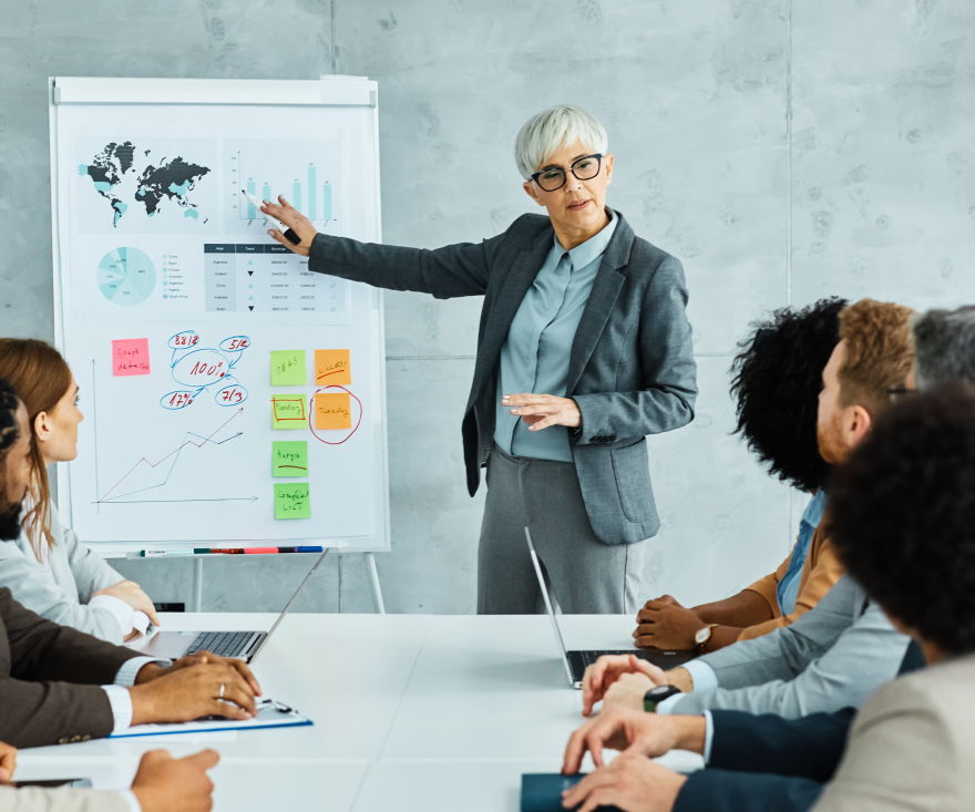 Executive presenting confidently in a boardroom—executive presence and wardrobe aligned with leadership