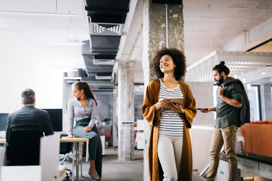 Confident leader walking through modern office with calm focus and purpose, symbolizing clarity, resilience, and empowered leadership