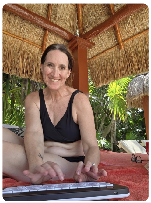 Carolyn writing poolside in Mexico
