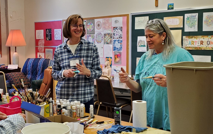 retreat participants smiling and picking colors for their paintings