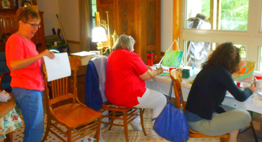 Three people making art at a Transitions Retreat