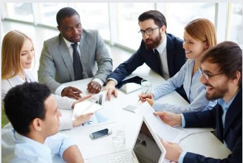 Business people around a table, in a focused meeting