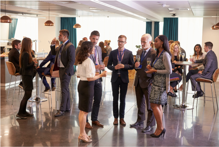 med and women standing and talking with one another