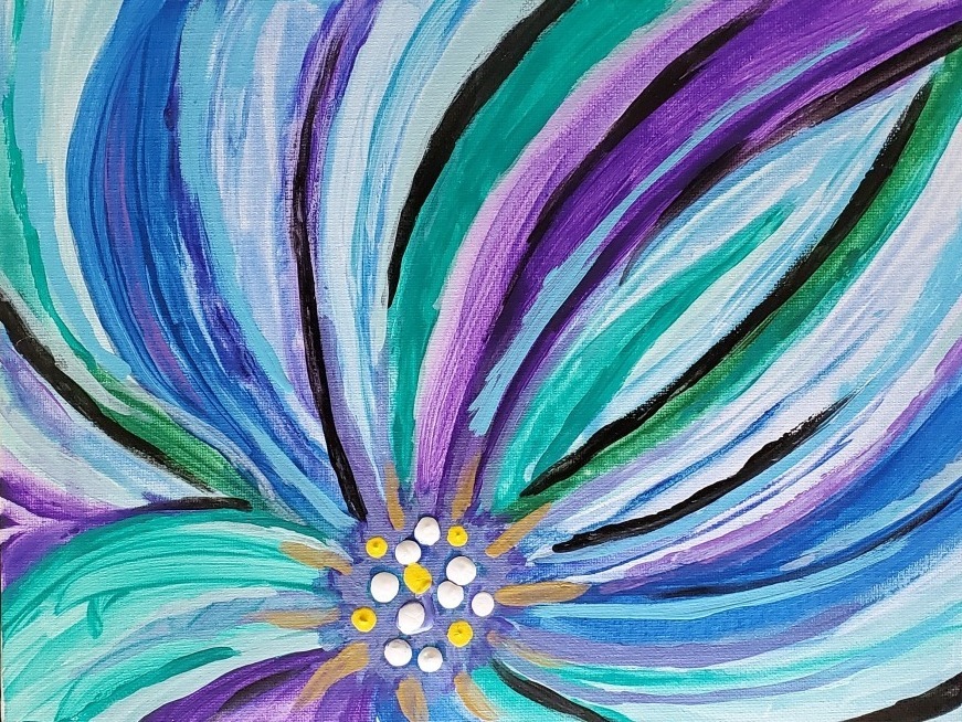 close up of a painted flower with blue, purple and green petals