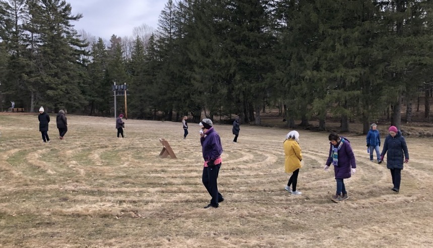 People walking in an outdoor labyrinth