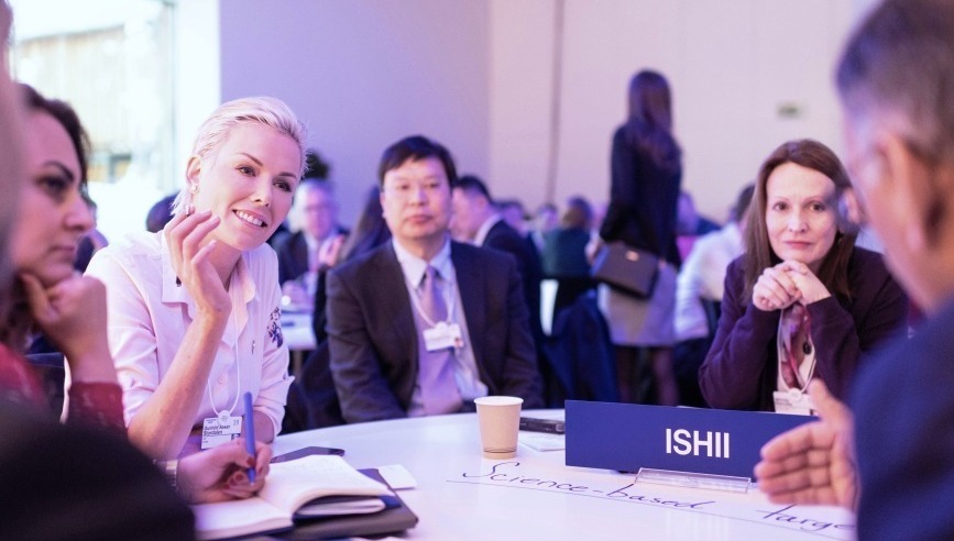 Women and men talking around a conference round table