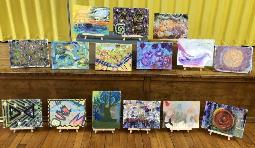 Intuitive paintings lined up in rows for display